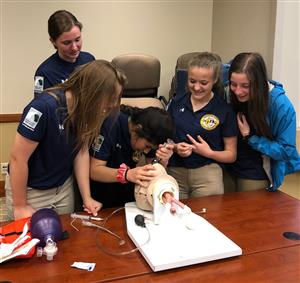 Practicing intubation on a mannequin head at Community Medical Center 